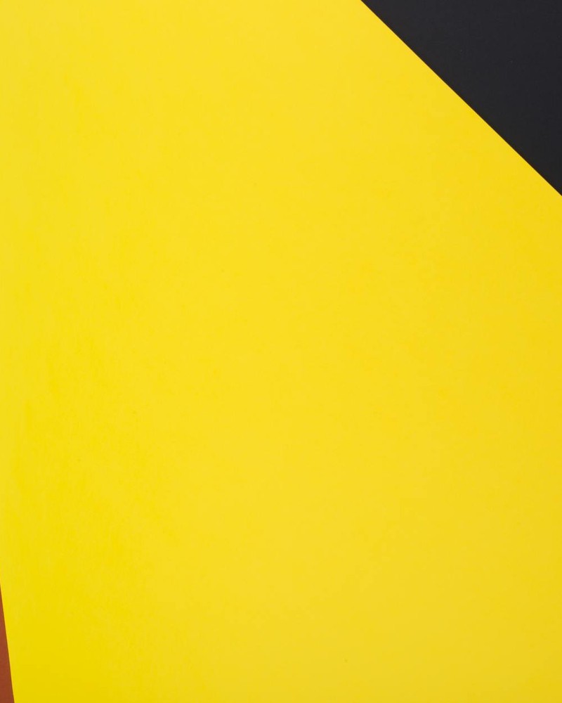 Vibrant abstract geometric design with bold yellow, red, and black colors.